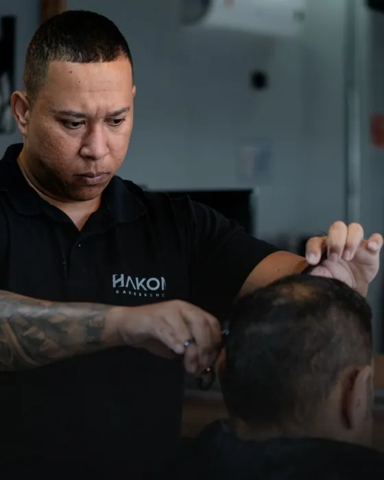 Jeferson Hakon, o Jefão, cortando o cabelo de um cliente